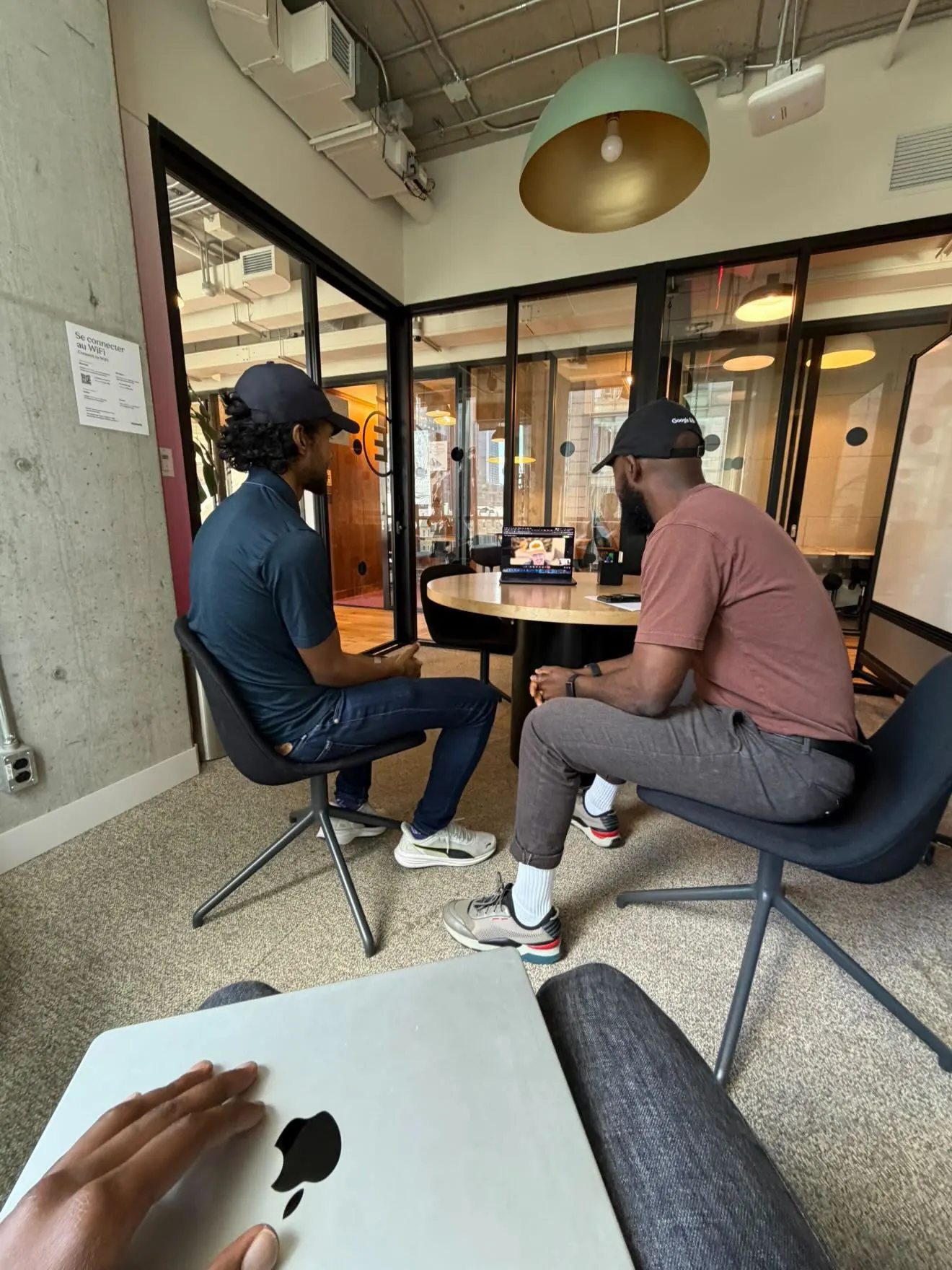 Two Oloodi team members in conversation at the studio